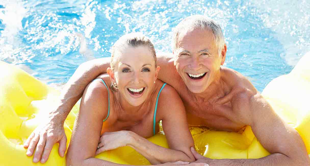 senior couple enjoying the swimming pool